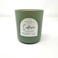12 oz scented soy candle in matte green glass jar, label centered