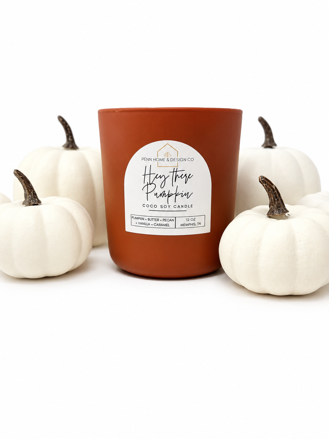 12 oz orange soy candle jar with 'Hey there pumpkin' label, flanked by white pumpkins